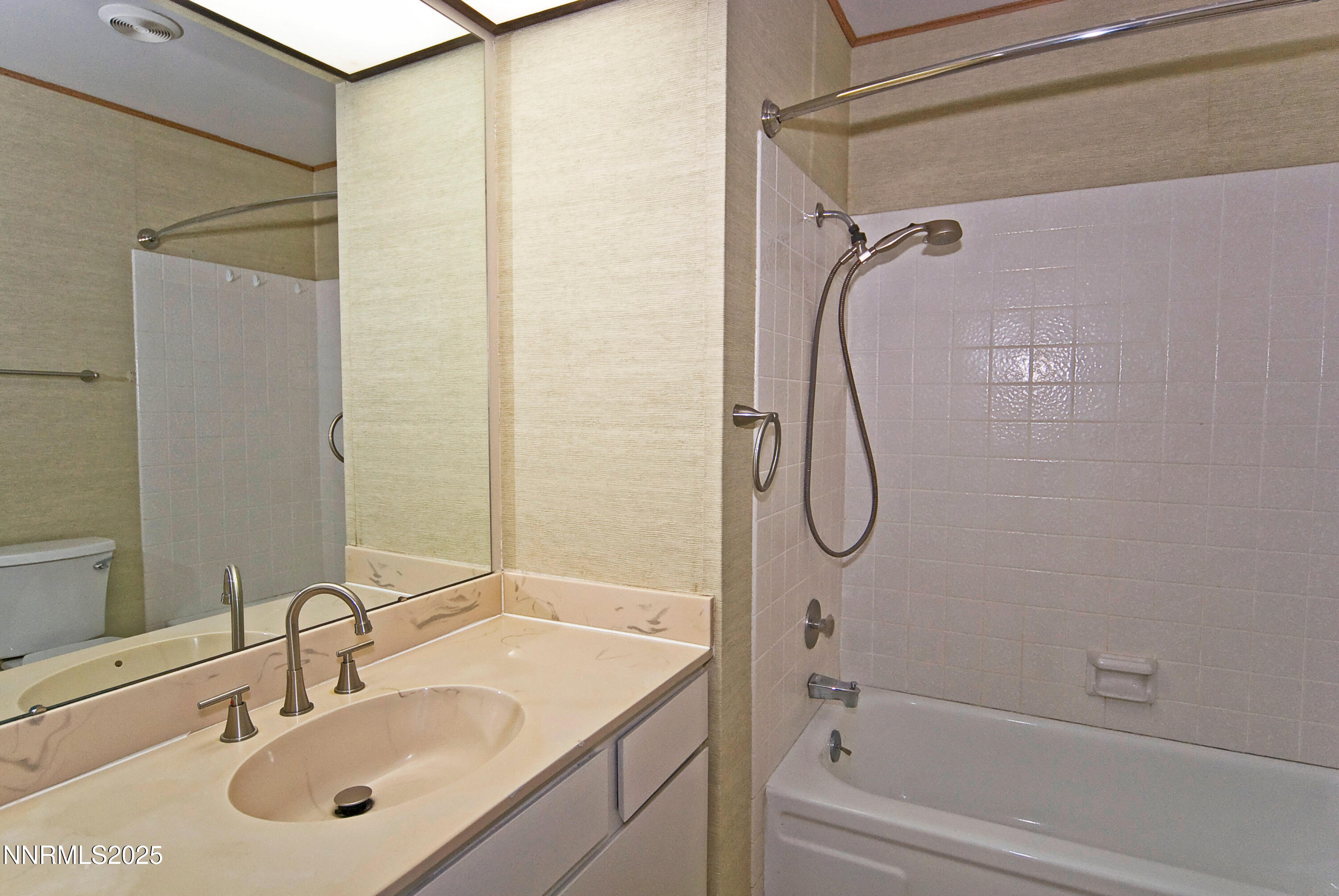 1433 Foster Drive Reno, NV 89509 - Photo 19 of 23 a bathroom with a granite countertop sink vanity mirror and shower