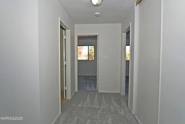 a view of hallway with bathroom