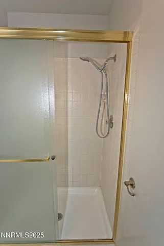 a bathroom with a glass shower door