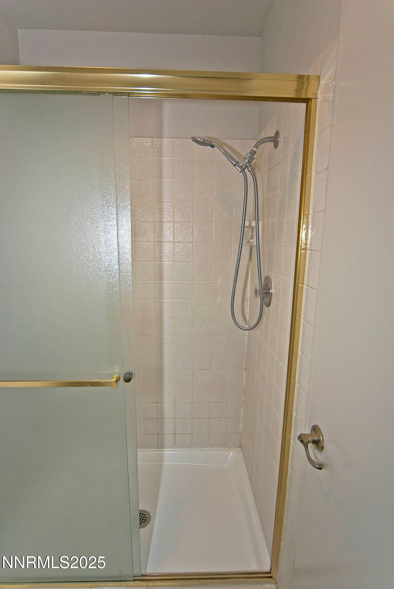 1433 Foster Drive Reno, NV 89509 - Photo 22 of 23 a bathroom with a glass shower door