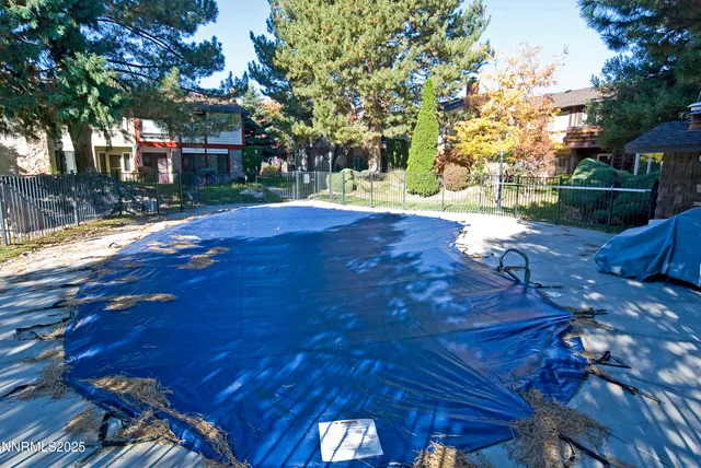 a view of yard with tree and wooden fence