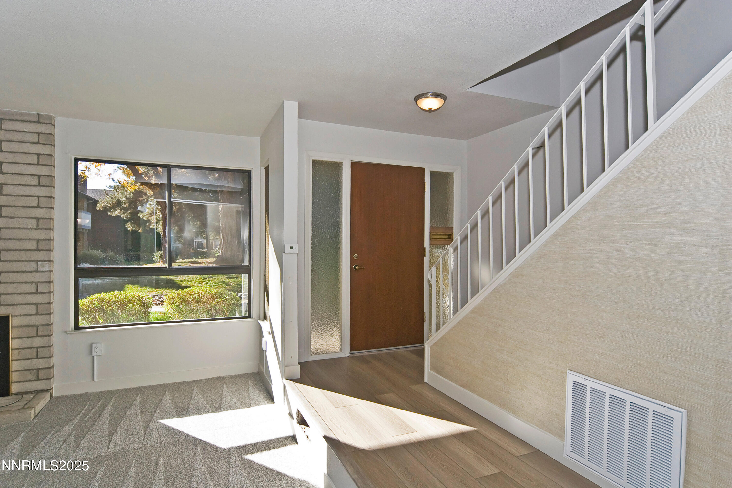 1433 Foster Drive Reno, NV 89509 - Photo 5 of 23 a view of a living room and dining room with wooden floor