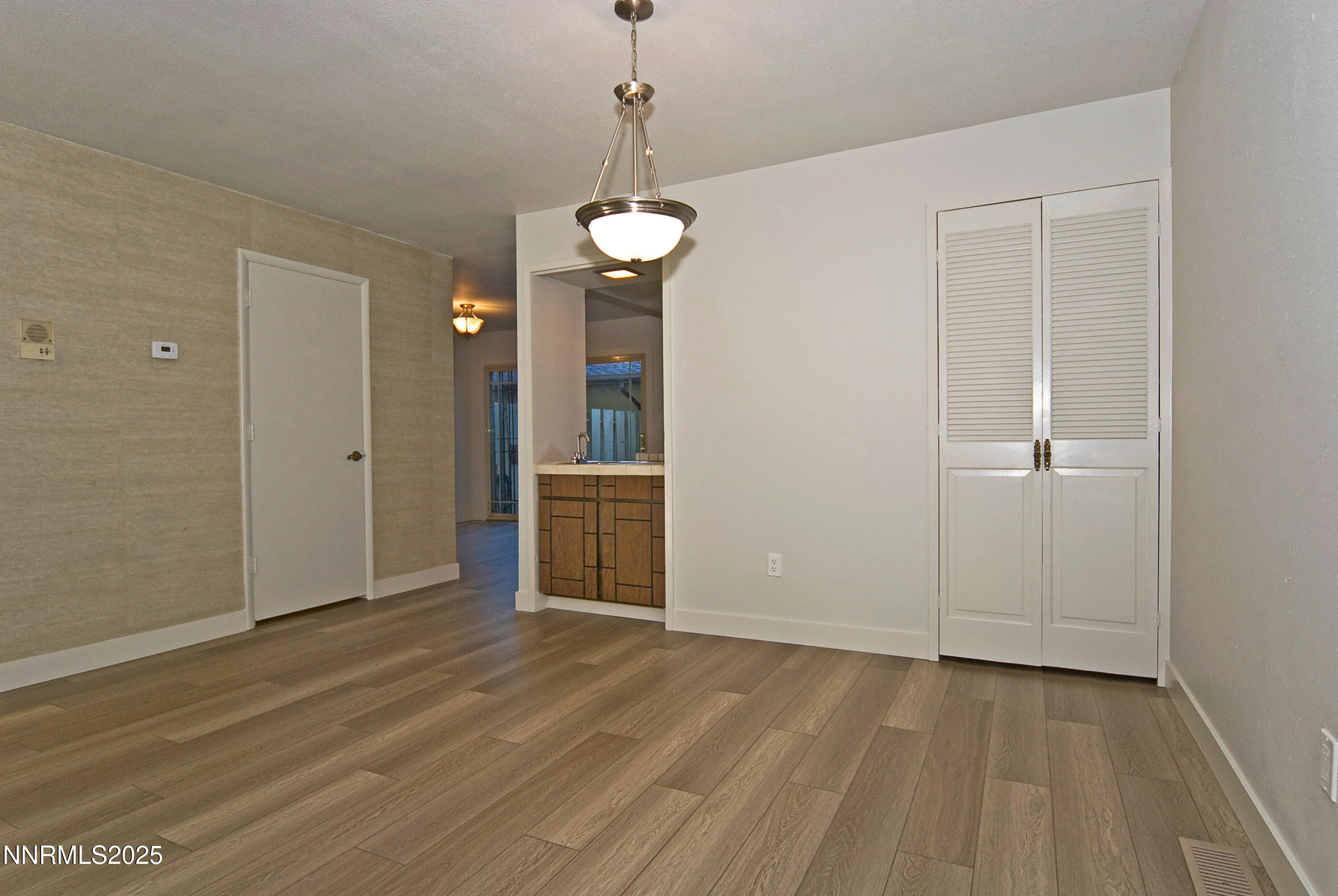 1433 Foster Drive Reno, NV 89509 - Photo 6 of 23 an empty room with wooden floor cabinet and windows