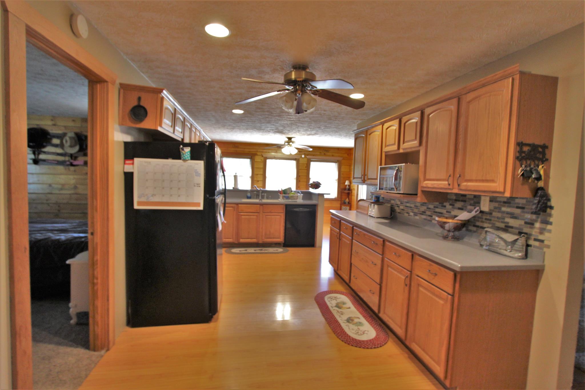 2296 Tracy Road Watertown, TN 37184 - Photo 23 of 29 a kitchen with stainless steel appliances granite countertop a refrigerator a sink dishwasher a stove and a dining table with wooden floor