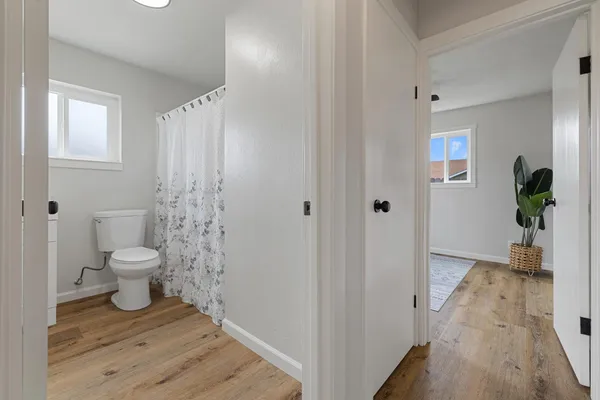 a bathroom with a toilet and a shower