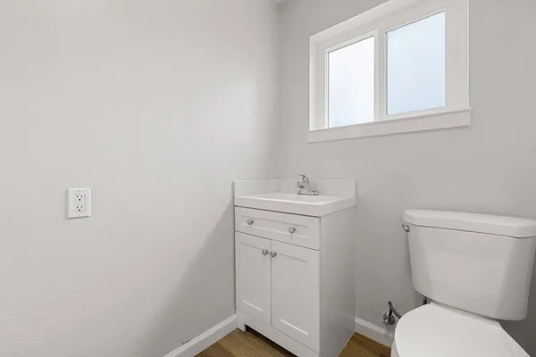 a bathroom with a toilet sink and mirror