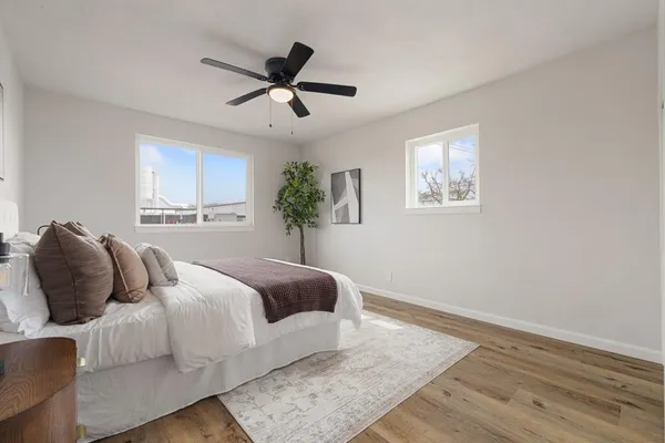 a bedroom with a large bed and a ceiling fan