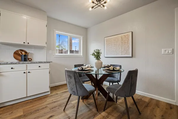 a view of a dining room with furniture and wooden floor