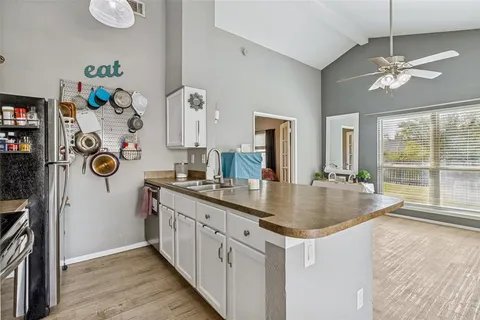 a kitchen with stainless steel appliances granite countertop a sink and a refrigerator