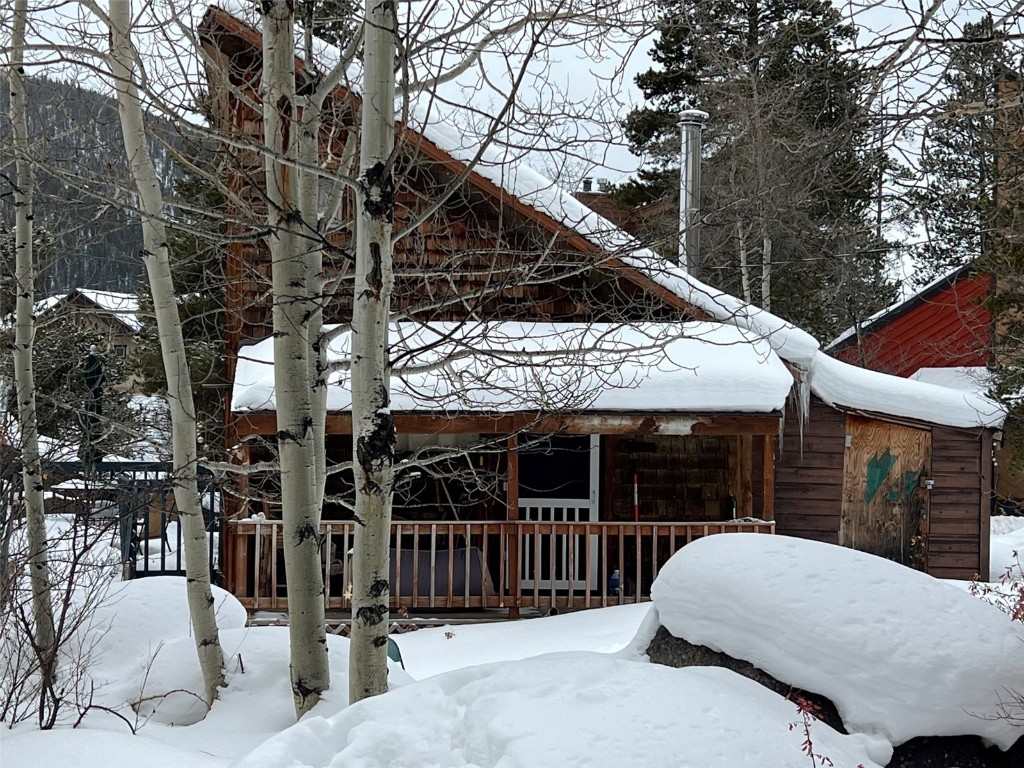 47 Rasor Court Keystone, CO 80435 - Photo 4 of 20 a view of a house with a wooden fence and a large tree