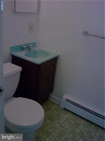 a bathroom with a toilet sink and mirror
