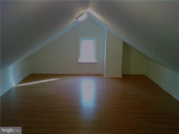 a view of room with window and wooden floor