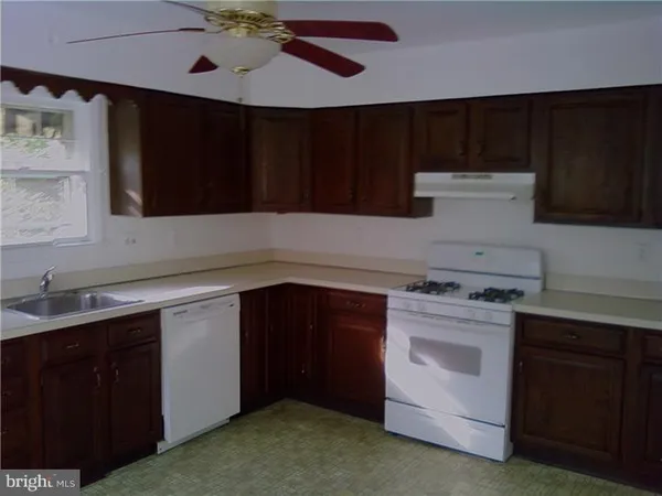 a kitchen with a cabinets and a stove top oven