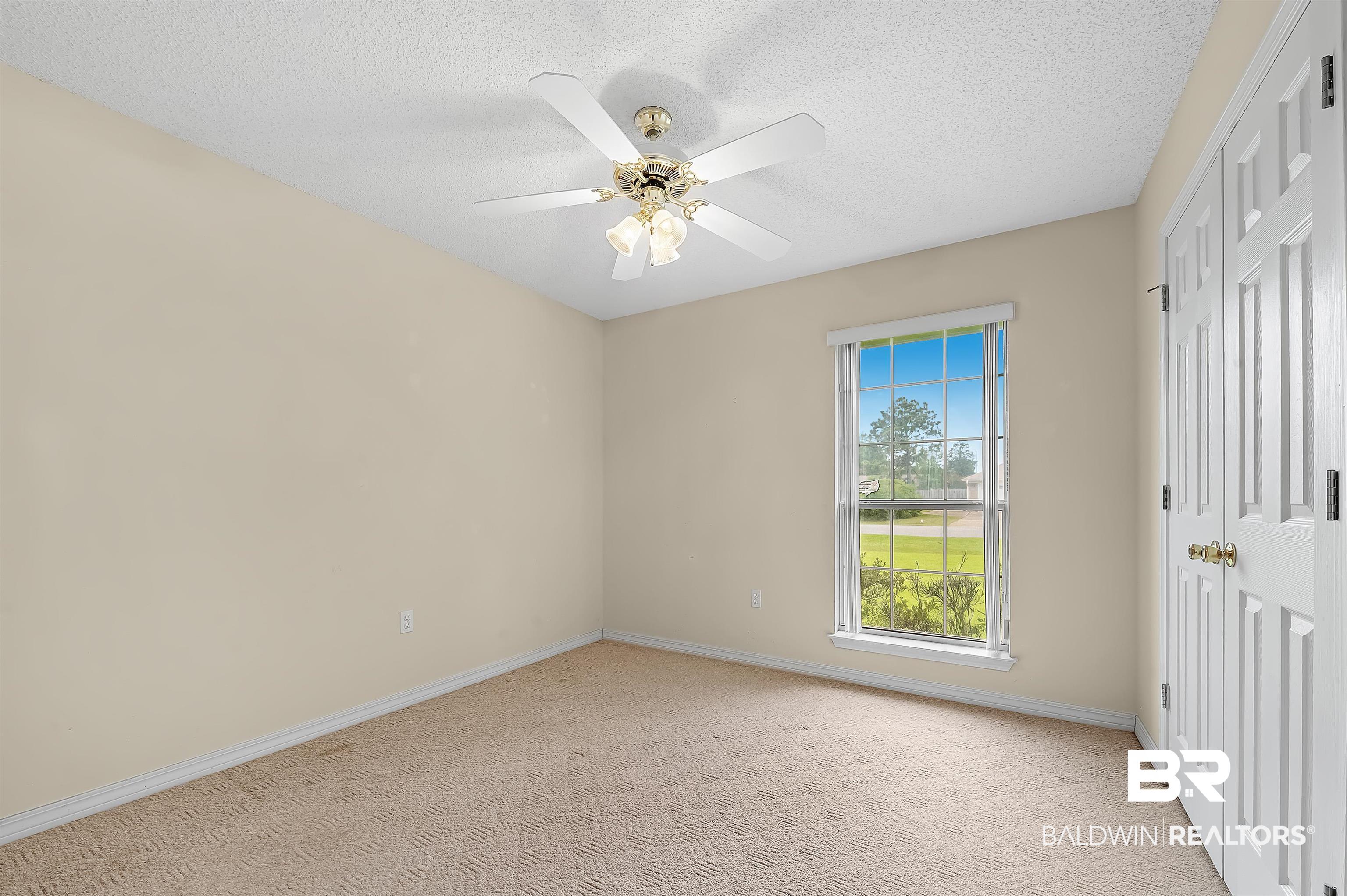 1502 Mulberry Lane Foley, AL 36535 - Photo 31 of 45 Unfurnished bedroom featuring light colored carpet, a textured ceiling, and ceiling fan