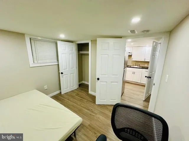 a room with wooden floor and furniture