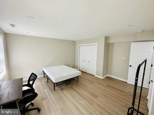 an empty room with windows and closet