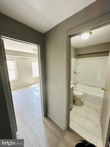 a bedroom with a bed and a mirror