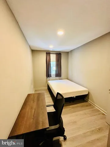 a kitchen with a table chairs microwave and refrigerator