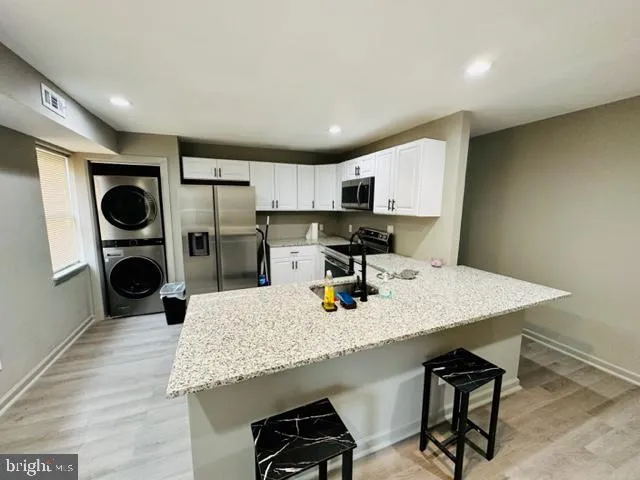 a kitchen with stainless steel appliances a refrigerator sink and cabinets