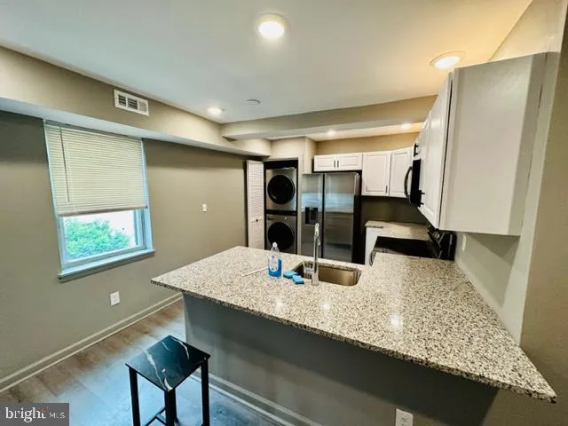 a view of a workspace with furniture and gym equipment