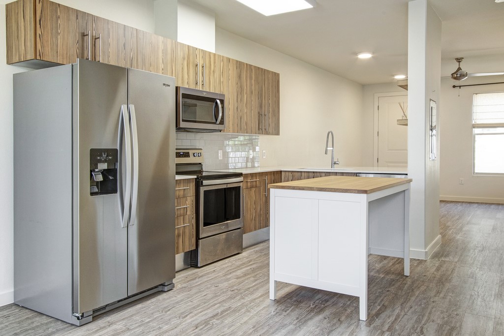 7805 Cooper Lane, Unit 602 Austin, TX 78745 - Photo 11 of 30 a kitchen with granite countertop a sink stove and refrigerator