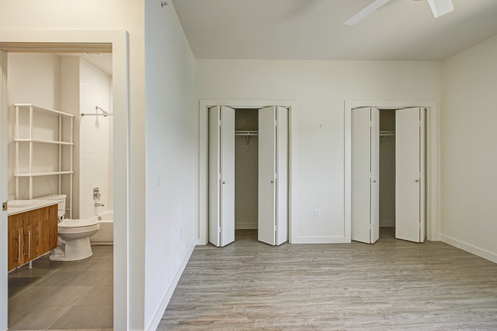 7805 Cooper Lane, Unit 602 Austin, TX 78745 - Photo 14 of 30 a view of a bathroom with a closet and wooden floor