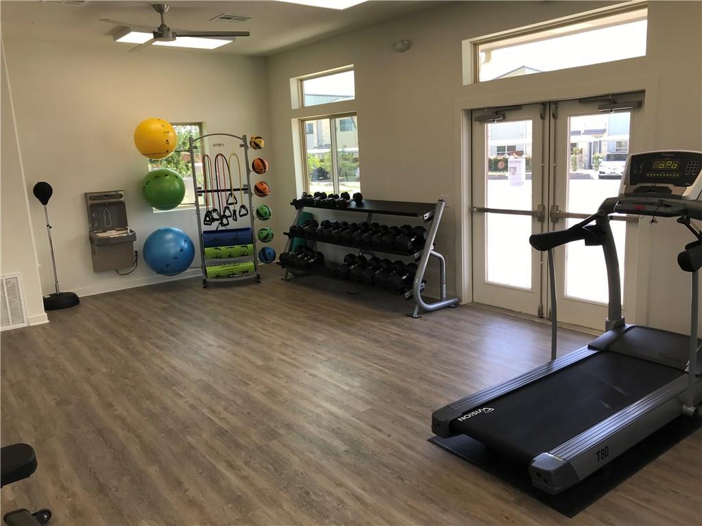 7805 Cooper Lane, Unit 602 Austin, TX 78745 - Photo 28 of 30 a bedroom with furniture and a wooden floor