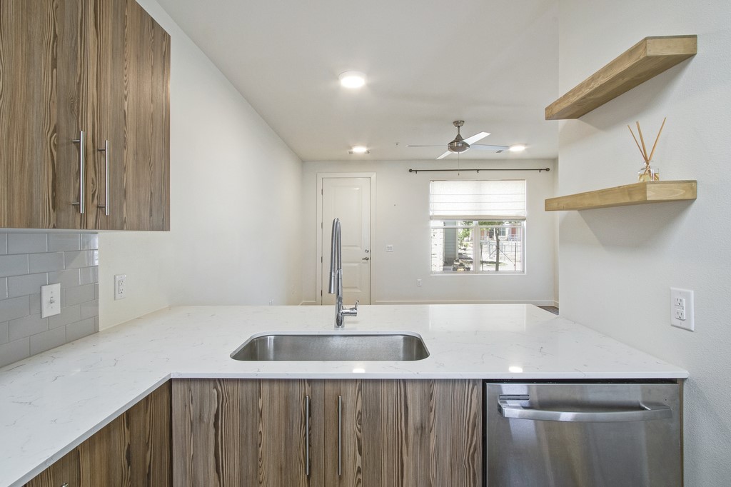 7805 Cooper Lane, Unit 602 Austin, TX 78745 - Photo 4 of 30 a kitchen with a sink and a refrigerator