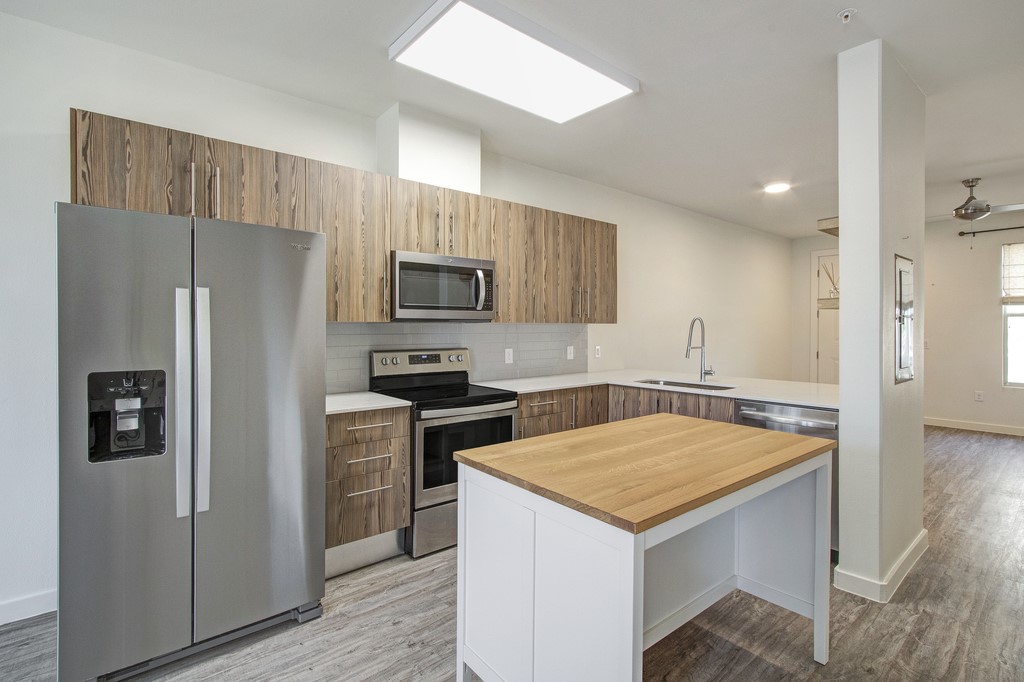 7805 Cooper Lane, Unit 602 Austin, TX 78745 - Photo 5 of 30 a kitchen with stainless steel appliances a refrigerator and a stove