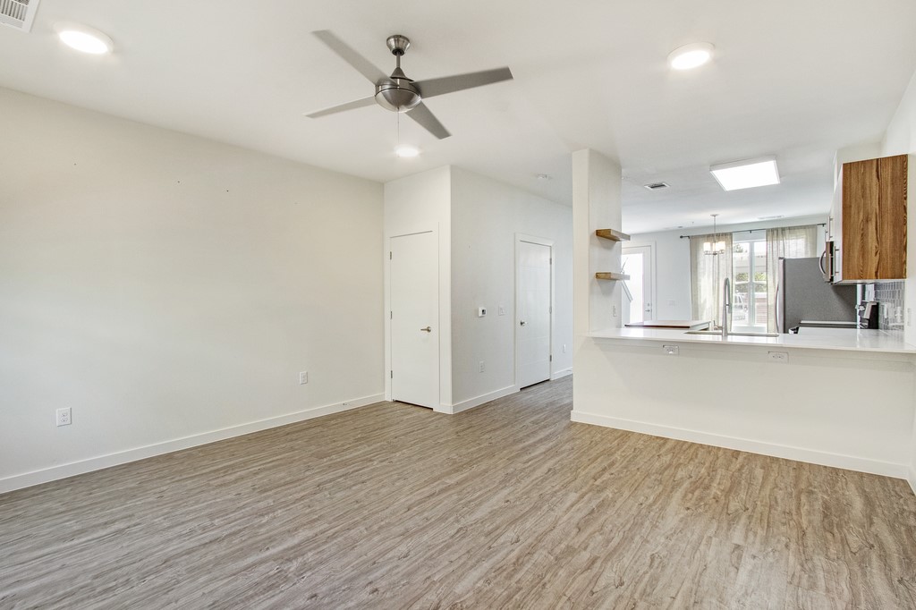 7805 Cooper Lane, Unit 602 Austin, TX 78745 - Photo 7 of 30 an empty room with wooden floor and windows