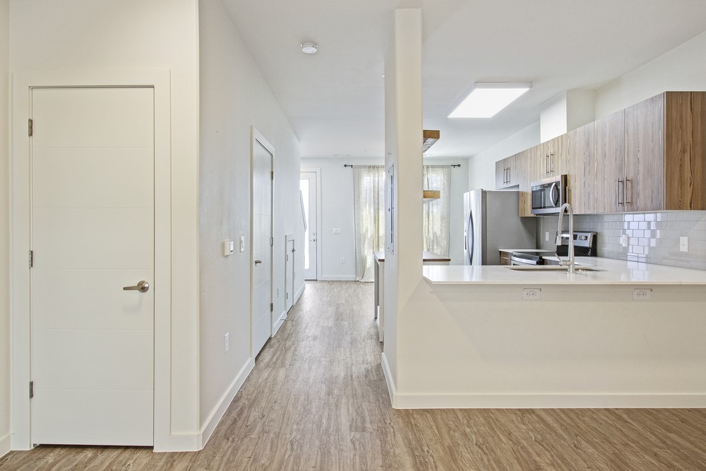 7805 Cooper Lane, Unit 602 Austin, TX 78745 - Photo 8 of 30 a view of a kitchen with kitchen island wooden floors stainless steel appliances