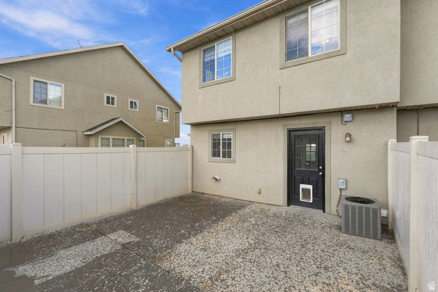 1041 South 1850th Street West Springville, UT 84663 - Photo 26 of 35 Enclosed patio area with a privacy fence, concrete surface, and stucco exterior