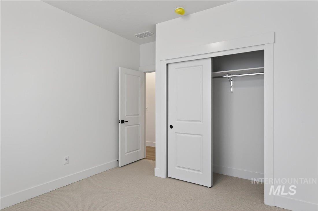 1268 West Swift Fox Street Meridian, ID 83642 - Photo 18 of 34 Unfurnished bedroom featuring light colored carpet and a closet