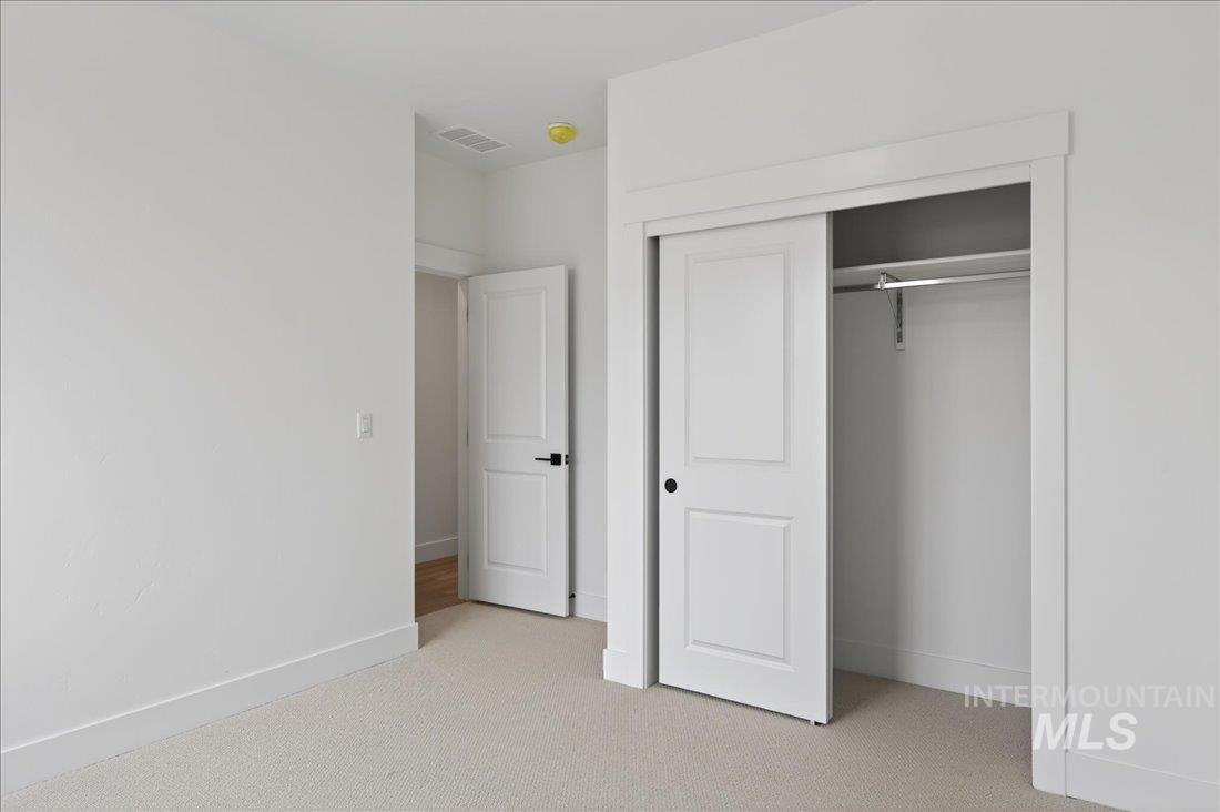 1268 West Swift Fox Street Meridian, ID 83642 - Photo 20 of 34 Unfurnished bedroom with light colored carpet and a closet