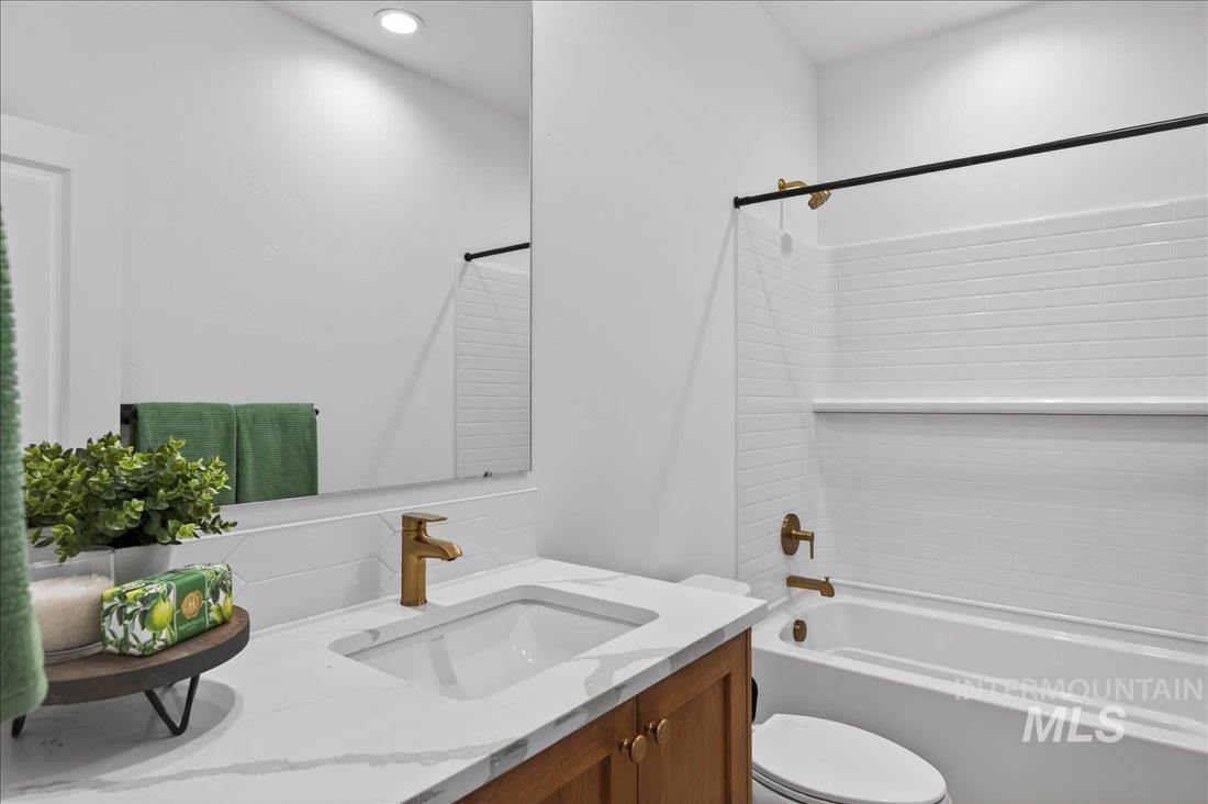 1268 West Swift Fox Street Meridian, ID 83642 - Photo 21 of 34 Bathroom with vanity, tub / shower combination, and decorative backsplash