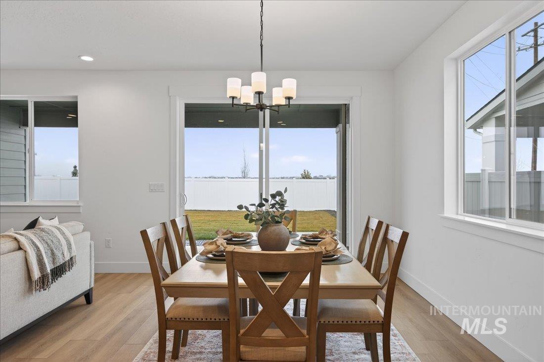 1268 West Swift Fox Street Meridian, ID 83642 - Photo 10 of 34 Dining room with plenty of natural light, light wood-type flooring, a chandelier, and recessed lighting