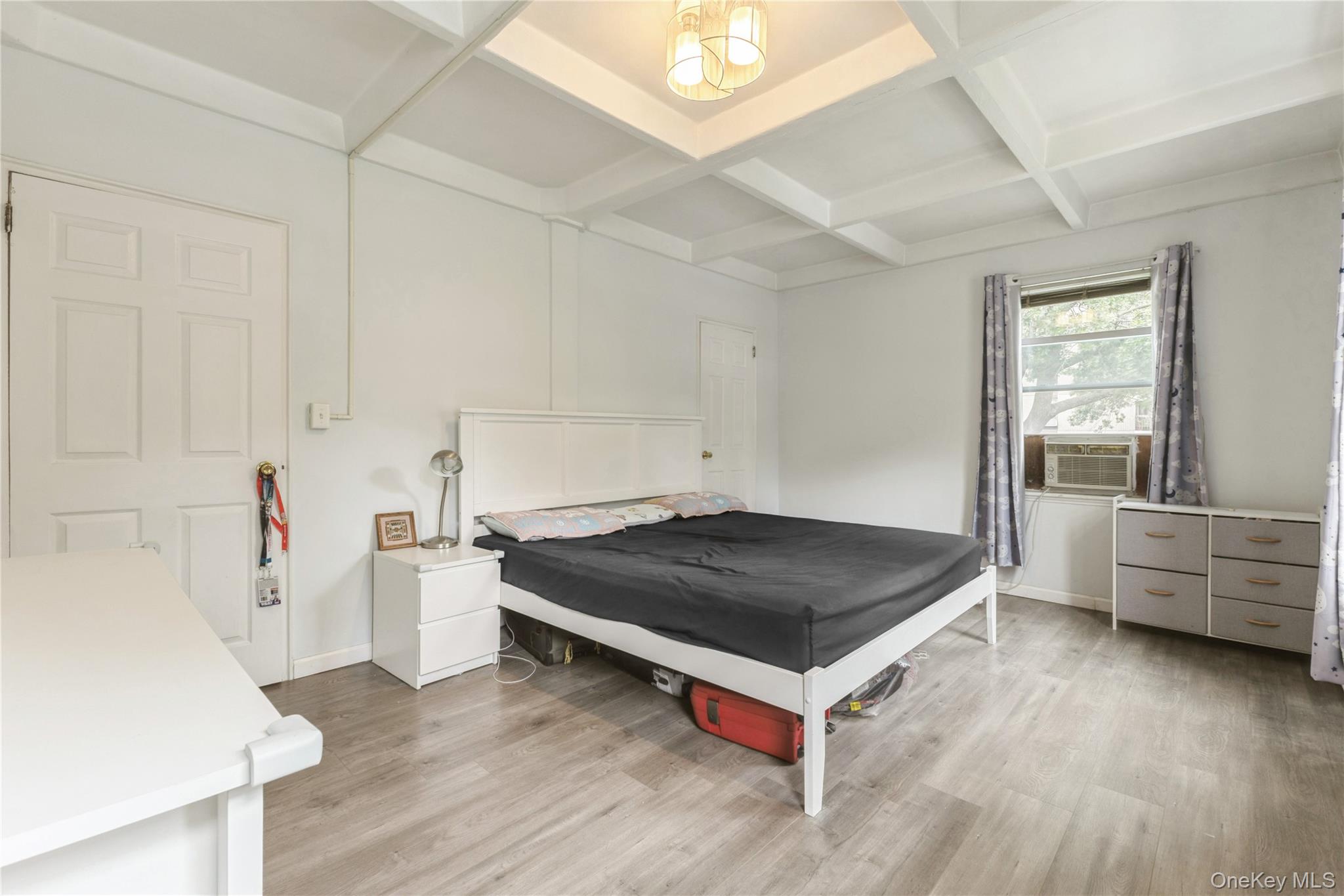 147-57 Charter Road, Unit 26D Queens, NY 11435 - Photo 10 of 21 Bedroom with beam ceiling, coffered ceiling, and light wood-type flooring