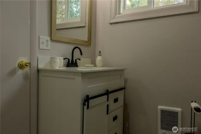 a bathroom with a sink and mirror