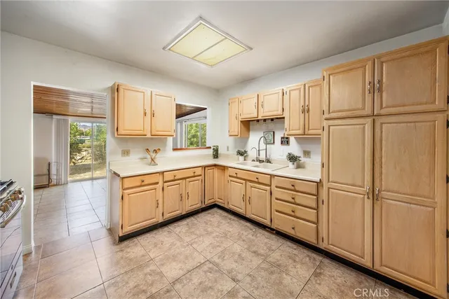 a kitchen with stainless steel appliances granite countertop a refrigerator sink and cabinets