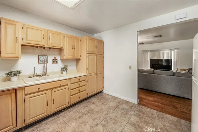 a kitchen with granite countertop white cabinets and stainless steel appliances