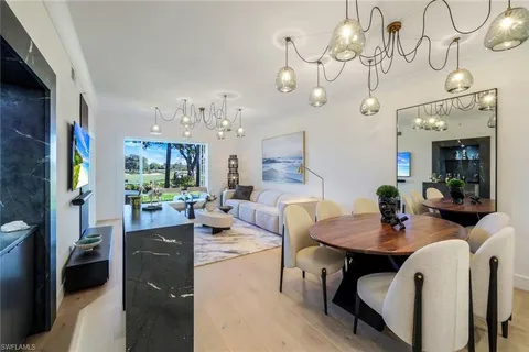 a view of a dining room with furniture and a chandelier