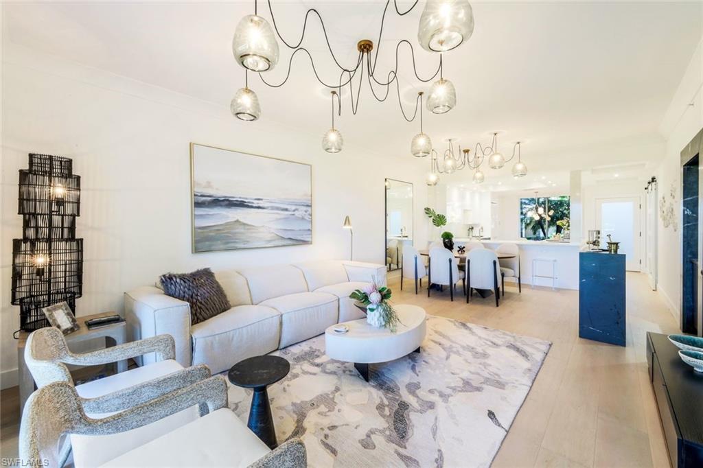 26871 Clarkston Drive, Unit 102 Bonita Springs, FL 34135 - Photo 14 of 50 a living room with furniture and a large window