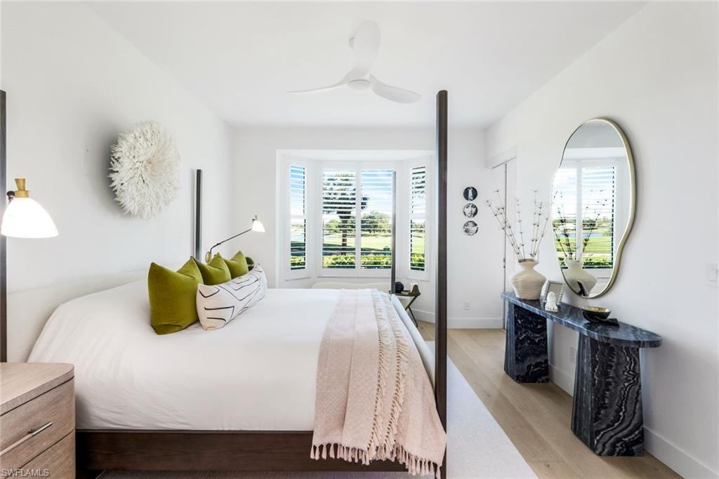 26871 Clarkston Drive, Unit 102 Bonita Springs, FL 34135 - Photo 19 of 50 a bedroom with a bed a window and painting on the wall