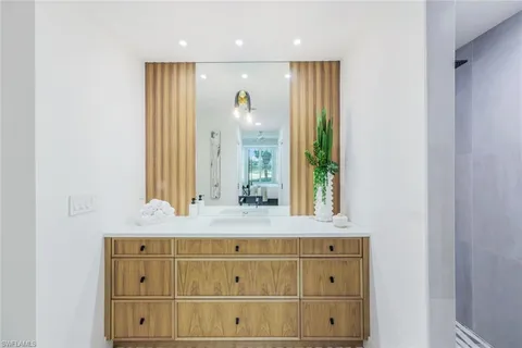 a bathroom with a mirror and a sink