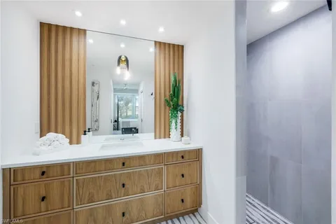a bathroom with a granite countertop sink mirror and double
