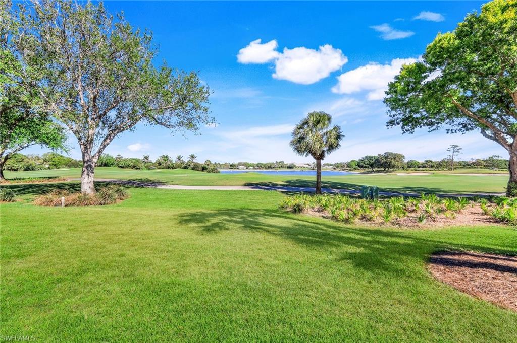 26871 Clarkston Drive, Unit 102 Bonita Springs, FL 34135 - Photo 24 of 50 a view of a golf course with a lake