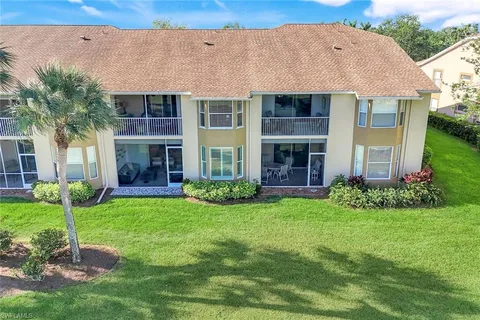 a view of a house with a yard and plants