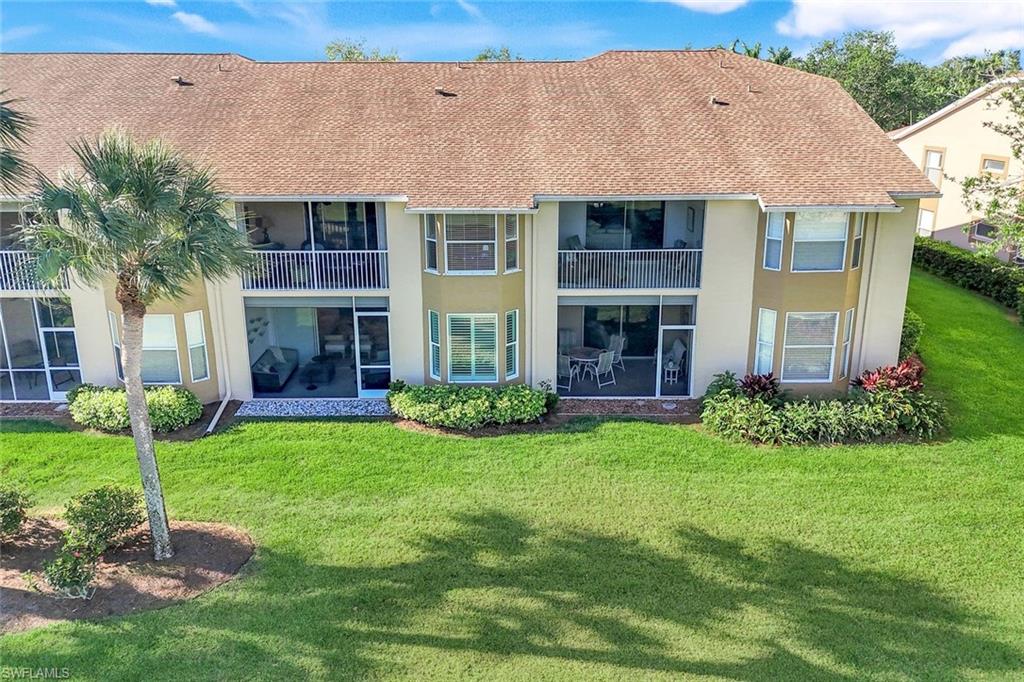 26871 Clarkston Drive, Unit 102 Bonita Springs, FL 34135 - Photo 29 of 50 a view of a house with a yard and plants