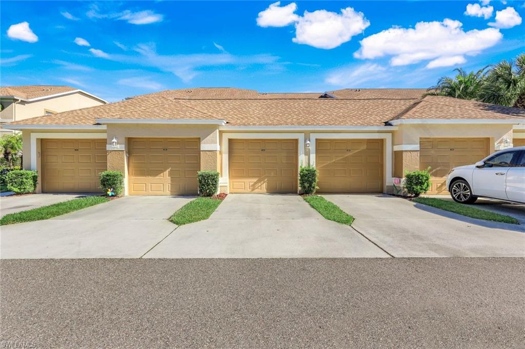 26871 Clarkston Drive, Unit 102 Bonita Springs, FL 34135 - Photo 33 of 50 front view of a house with a street