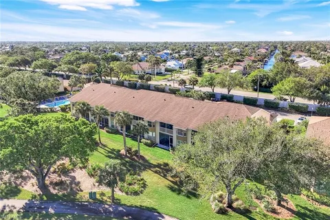 an aerial view of residential building and lake